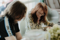 Zwei Menschen puzzeln am Tisch